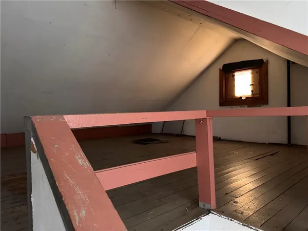 a view of an empty room and wooden floor