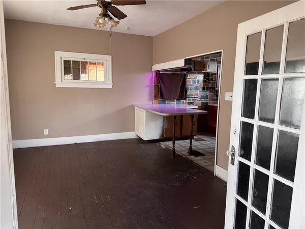 a workspace room with wooden floor windows and cabinet