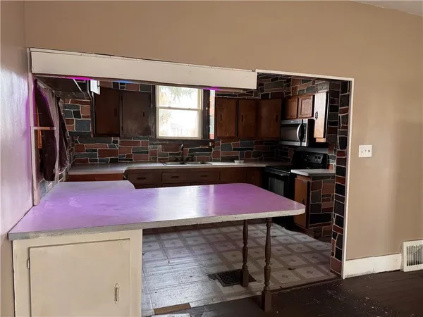 a kitchen with a stove a sink and a refrigerator