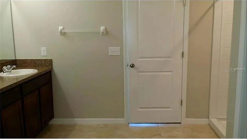 1606 Redmond Brook Lane Ruskin, FL 33570 - Photo 14 of 26 a bathroom with a granite countertop sink and mirror