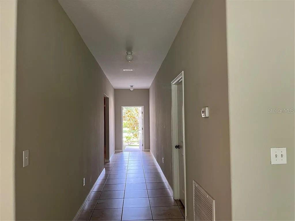 1606 Redmond Brook Lane Ruskin, FL 33570 - Photo 15 of 26 a view of a hallway with a chandelier