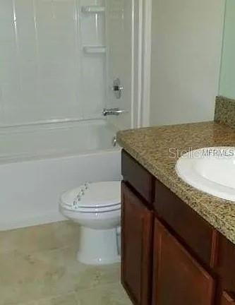 1606 Redmond Brook Lane Ruskin, FL 33570 - Photo 25 of 26 a bathroom with a granite countertop sink a toilet and shower