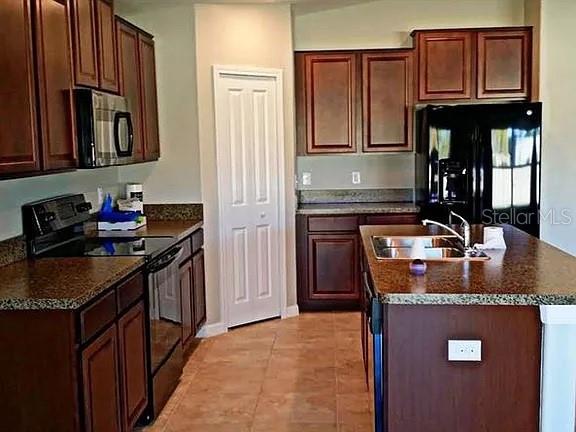 1606 Redmond Brook Lane Ruskin, FL 33570 - Photo 5 of 26 a kitchen with granite countertop a sink stove and cabinets
