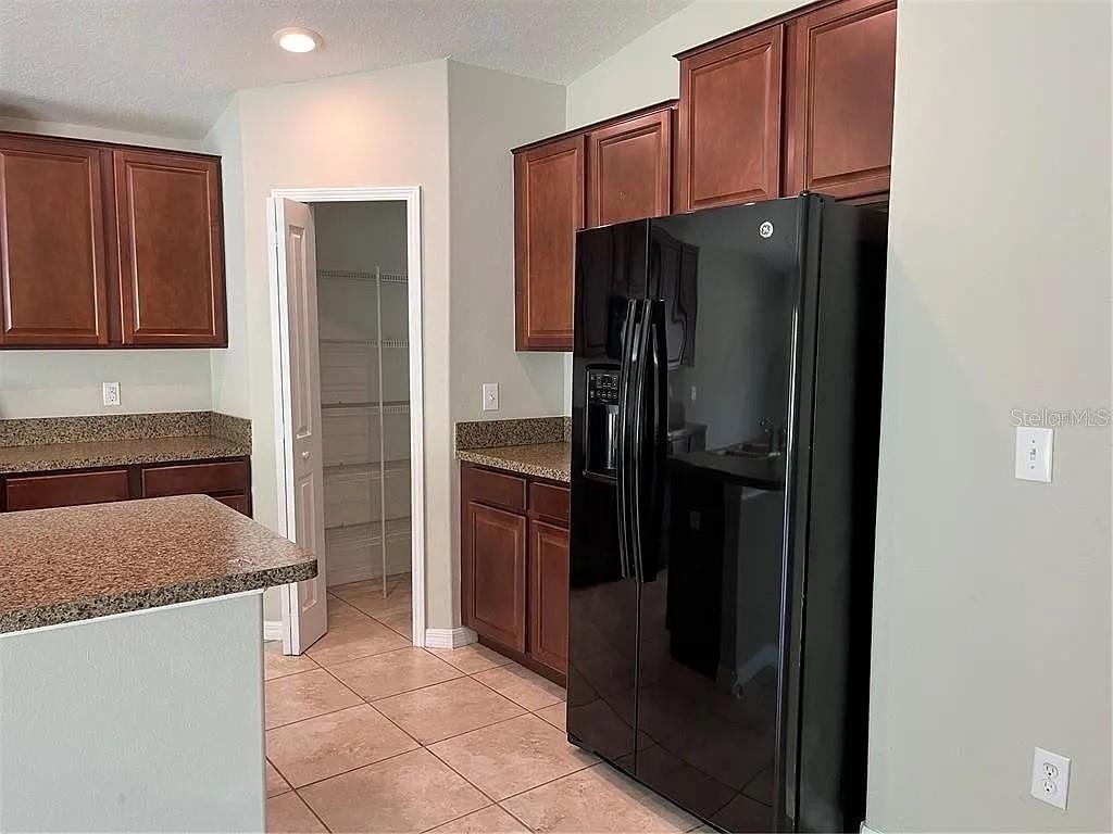 1606 Redmond Brook Lane Ruskin, FL 33570 - Photo 6 of 26 a kitchen with stainless steel appliances granite countertop a refrigerator and a sink