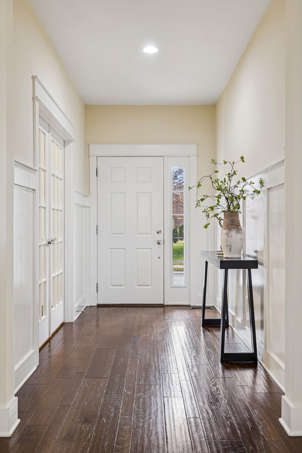 737 Newcomb Street Franklin, TN 37064 - Photo 8 of 99 a view of an empty room with wooden floor and a potted plant