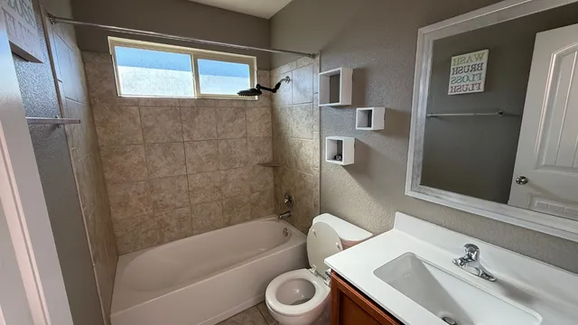 a bathroom with a sink toilet and shower