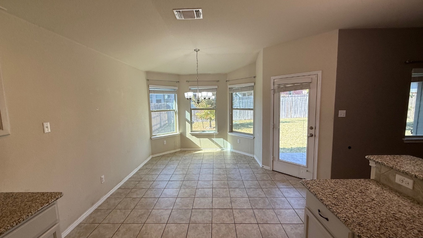 116 Zoisite Lane Jarrell, TX 76537 - Photo 2 of 21 a view of a hallway with windows and chandelier