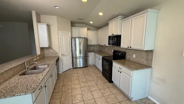 a kitchen with a sink stove and refrigerator