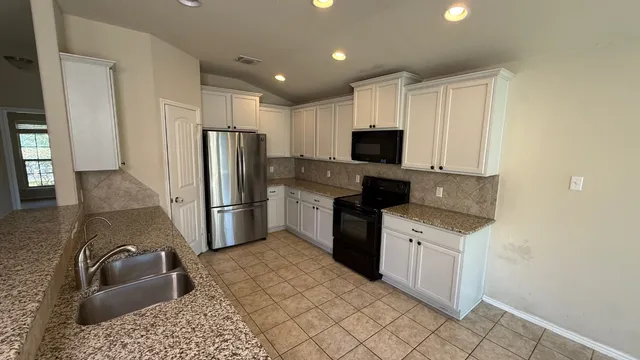 a kitchen with a refrigerator sink and microwave