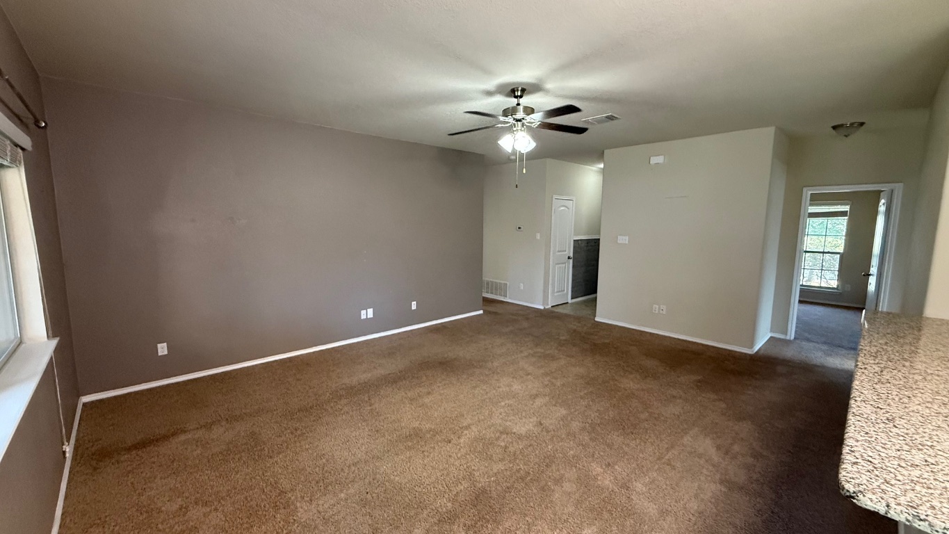 116 Zoisite Lane Jarrell, TX 76537 - Photo 7 of 21 wooden floor in an empty room with a window