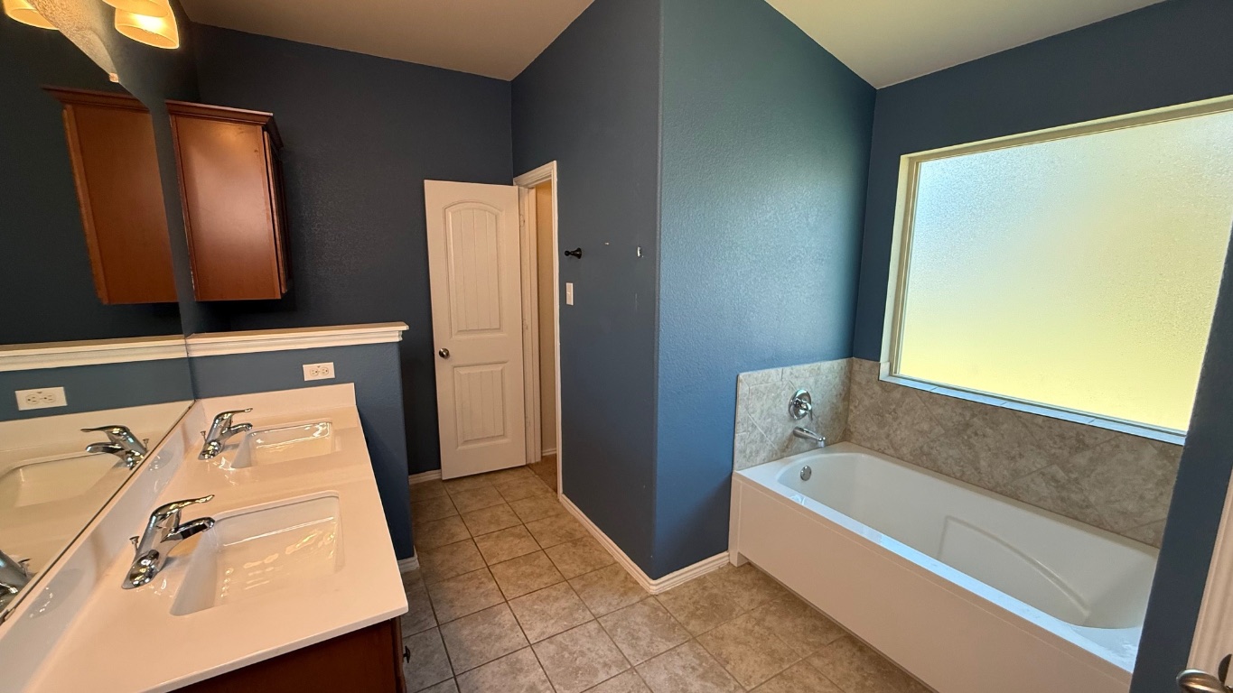 116 Zoisite Lane Jarrell, TX 76537 - Photo 9 of 21 a bathroom with a tub sink and mirror