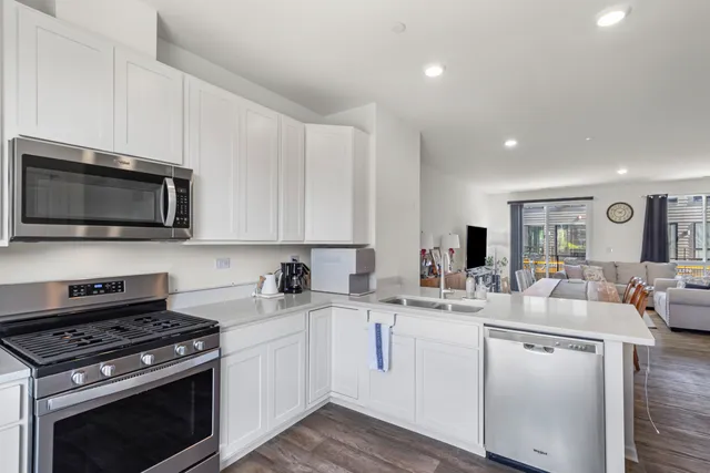 a kitchen with a sink stove and microwave