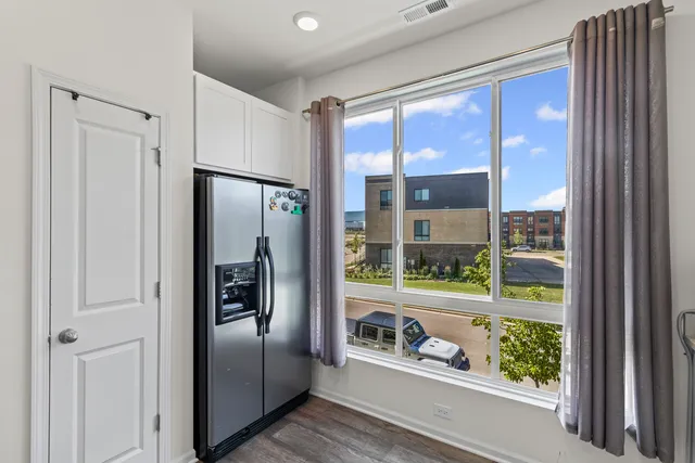 a kitchen with a refrigerator and a large window
