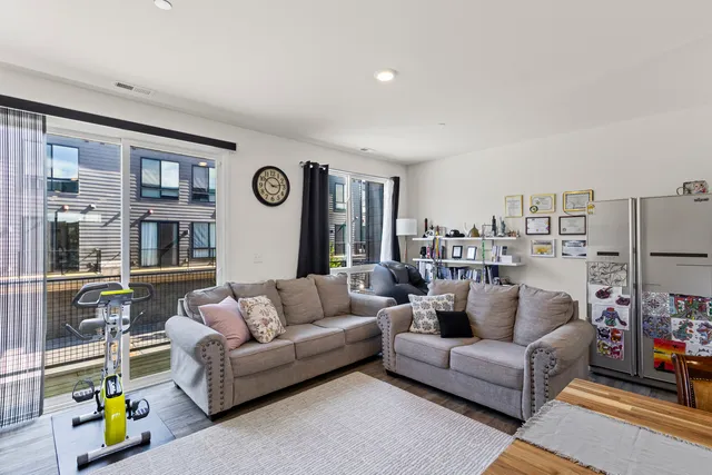 a living room with furniture and a clock