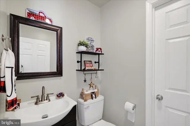 a bathroom with a toilet a sink and a mirror
