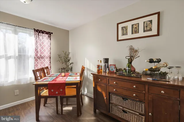 a dining room with a wooden table and chairs