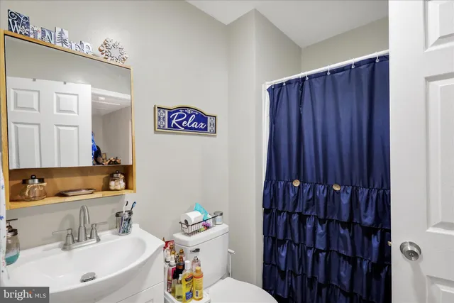 a bathroom with a sink toilet and vanity