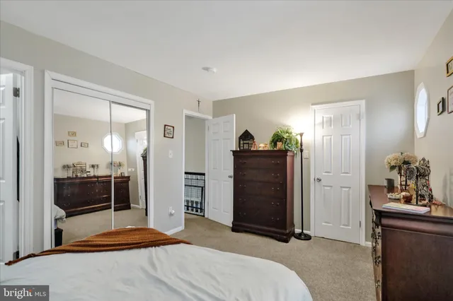 a bedroom with a bed and a mirror