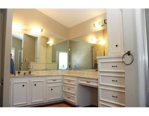 a bathroom with a granite countertop sink mirror and a