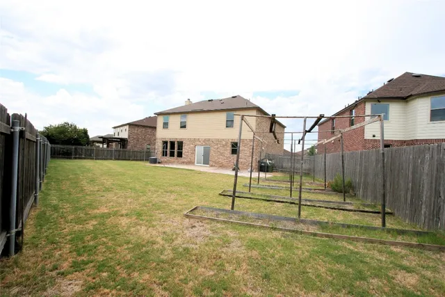 a view of a house with a backyard