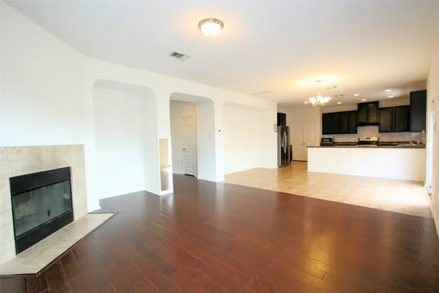 a view of a kitchen with a sink and a fireplace