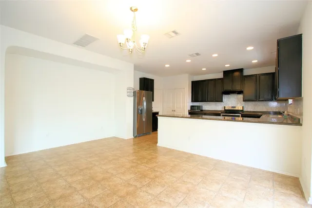 a view of kitchen with microwave and refrigerator