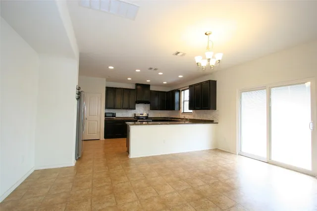 a large kitchen with a large counter top appliances and cabinets