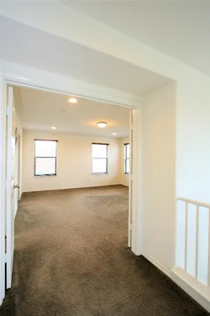 an empty room with windows and closet