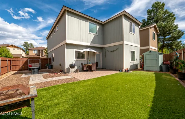 a view of a patio with table and chairs with wooden floor and fence