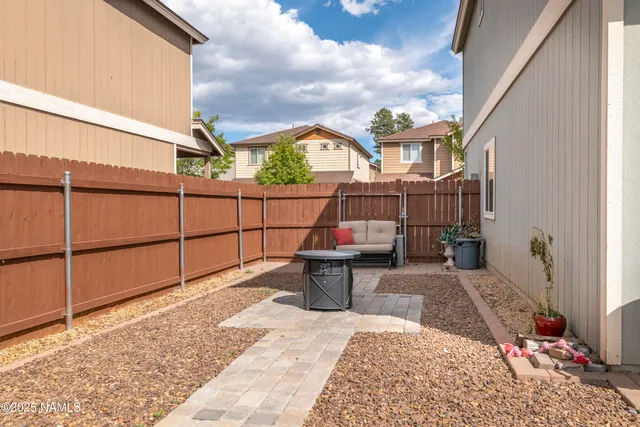 a view of a patio with a table and chairs