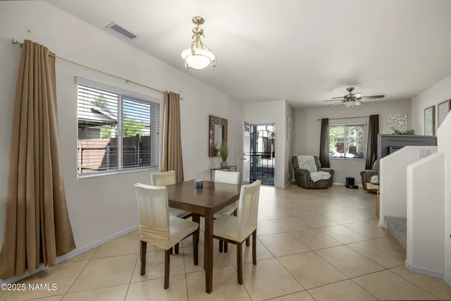 a dining room with furniture and a chandelier