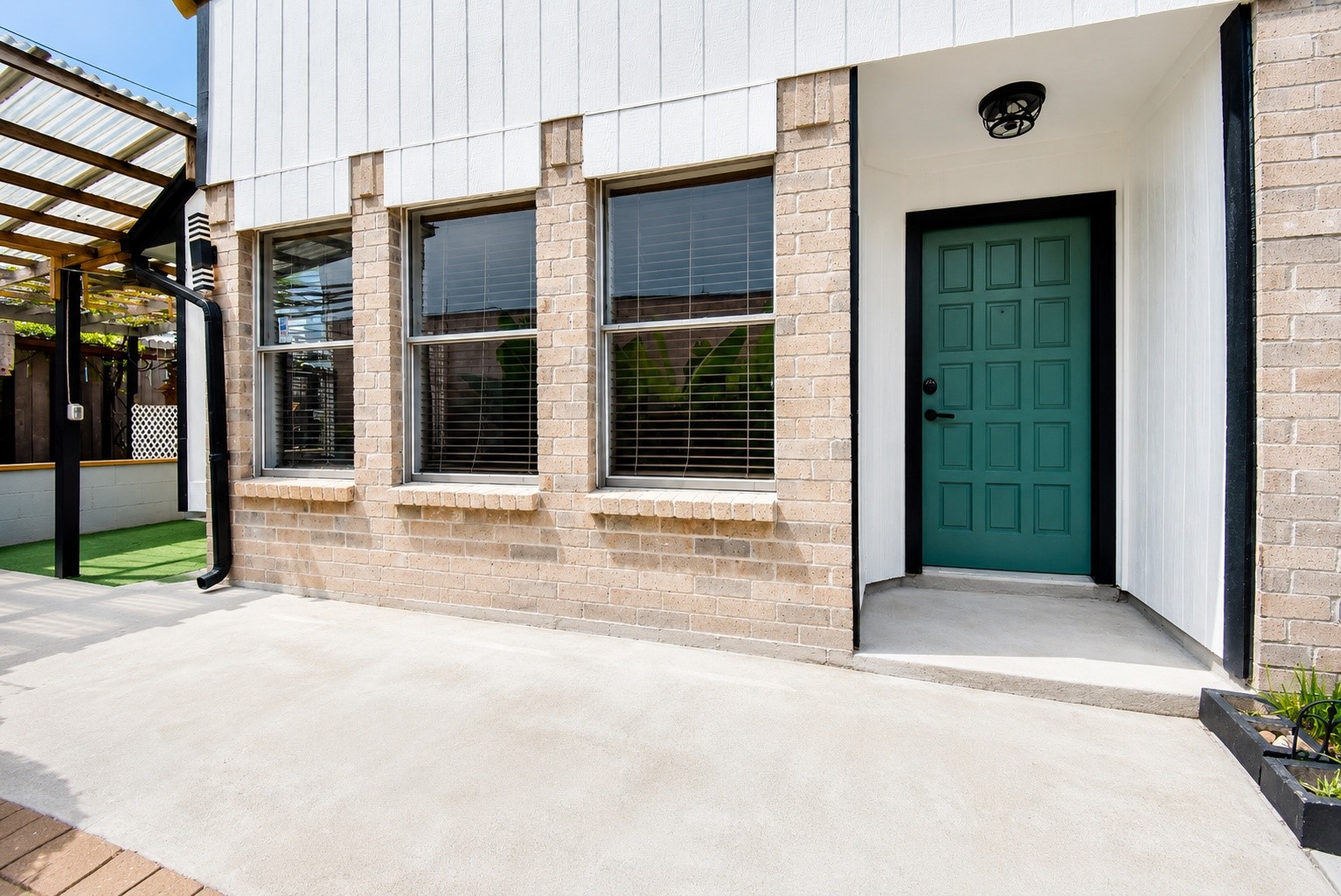 8715 Vinkins Road Houston, TX 77071 - Photo 7 of 48 The inviting main entrance is tucked within a private courtyard, providing a welcoming arrival and a seamless transition into this beautifully updated home.