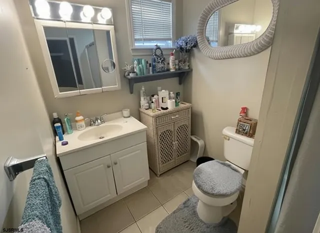 a bathroom with a sink toilet and mirror
