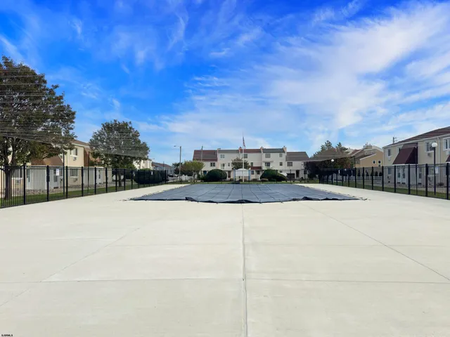 a view of swimming pool with outdoor seating and city view