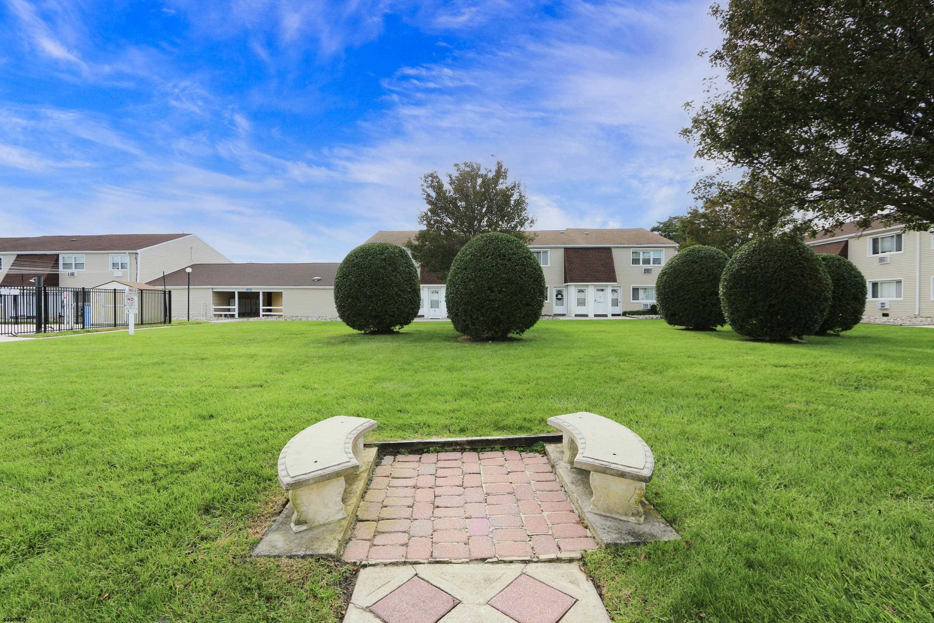 4901 Harbor Beach Boulevard, Unit P8 Brigantine, NJ 08203 - Photo 19 of 39 a view of a chair and table in backyard of the house