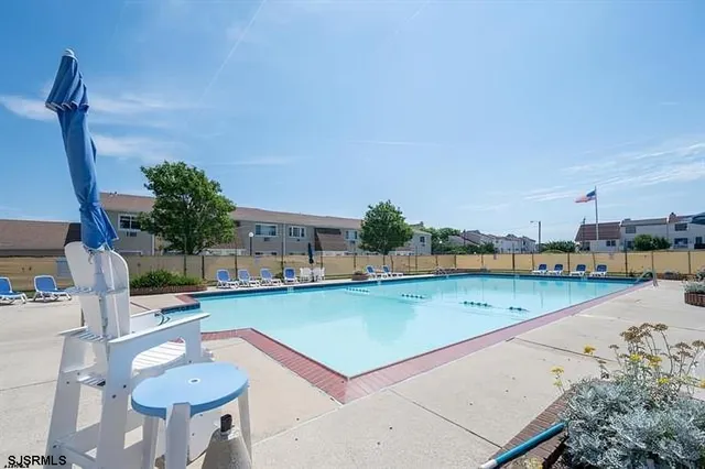 a view of a swimming pool and lounge chair