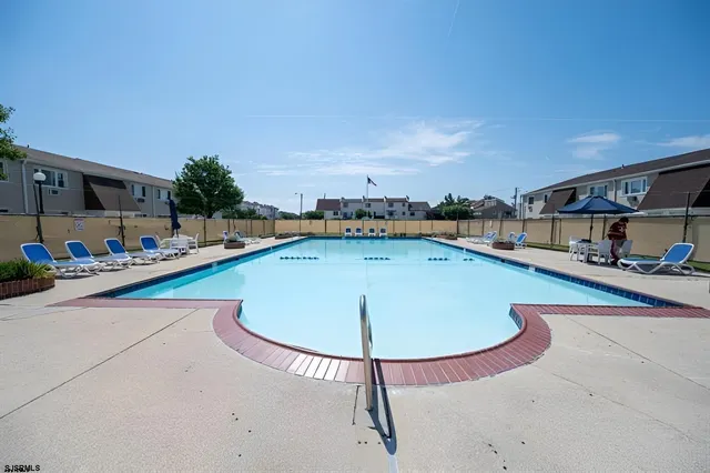 a view of a swimming pool with an outdoor seating