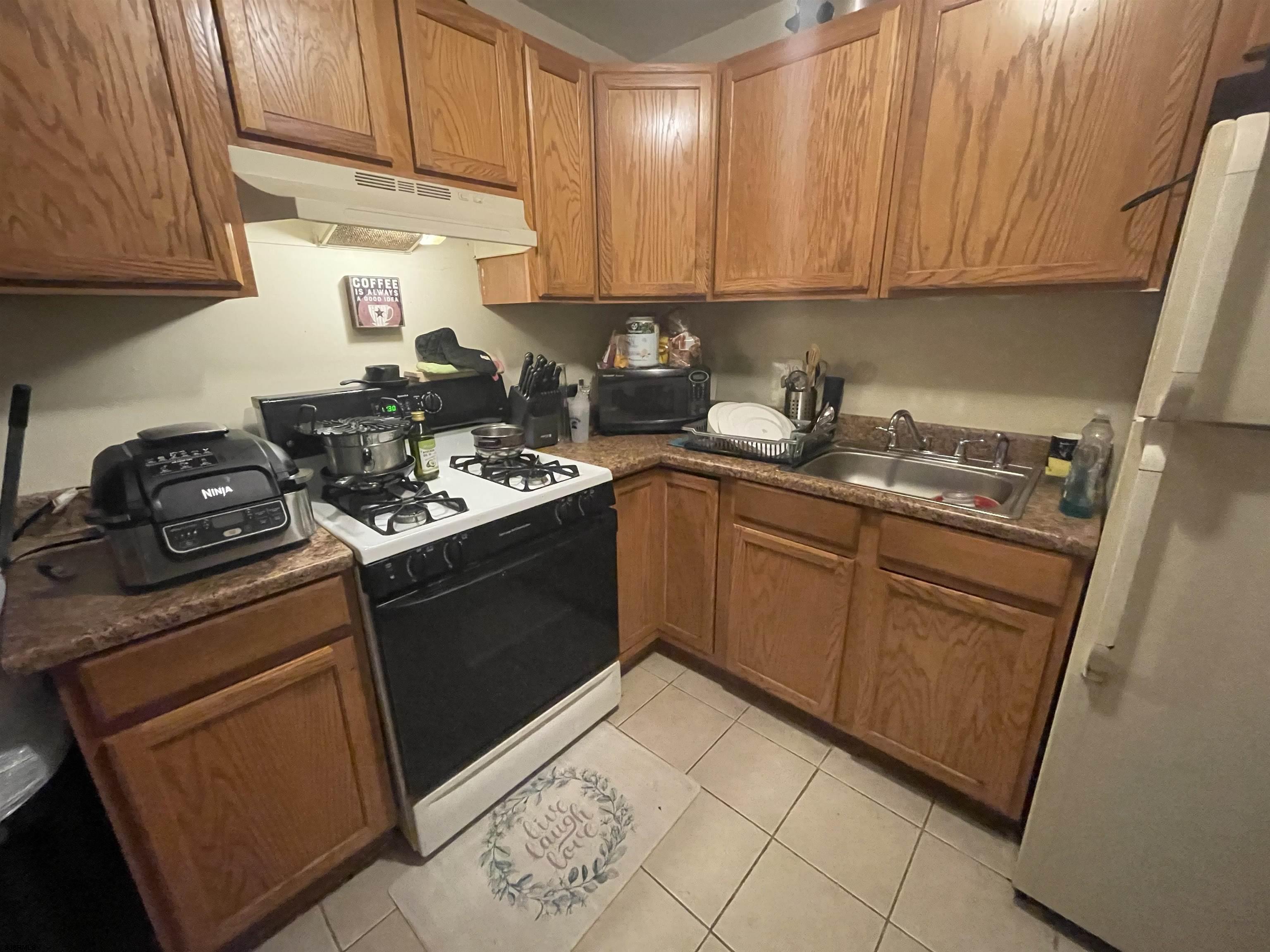 4901 Harbor Beach Boulevard, Unit P8 Brigantine, NJ 08203 - Photo 6 of 39 a kitchen with stainless steel appliances granite countertop a stove sink and cabinets