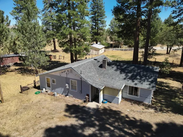 a view of a house with a yard and sitting area