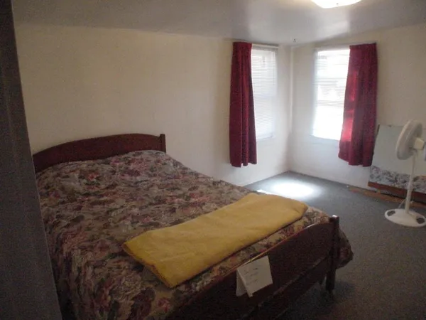 a bedroom with a bed and window