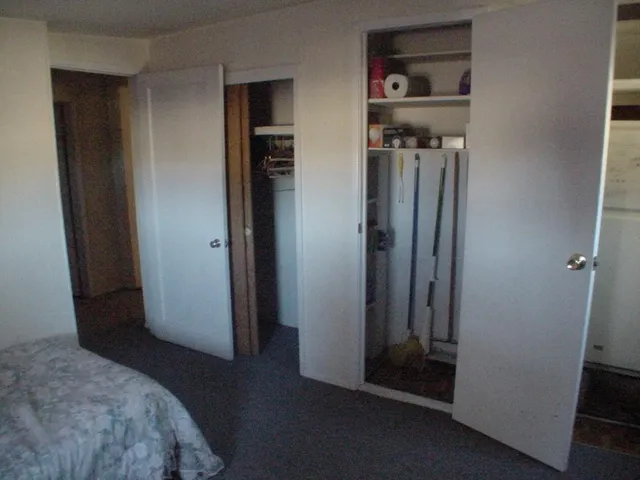 a bedroom with a bed and cabinets