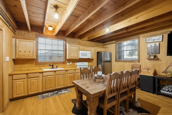 a kitchen with lots of counter top space and dining table
