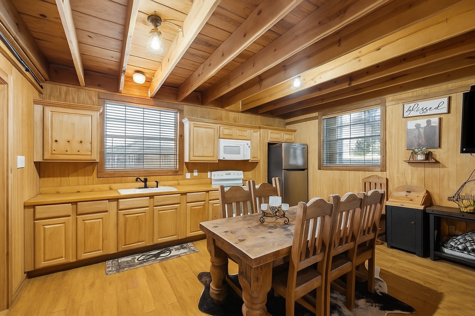 40570 Wildlife Run Hempstead, TX 77445 - Photo 23 of 43 The guest house kitchen includes abundant cabinetry, a full appliance suite, and a spacious dining area beneath exposed beams. It’s a fully functional space designed for cooking, entertaining, or extended stays.