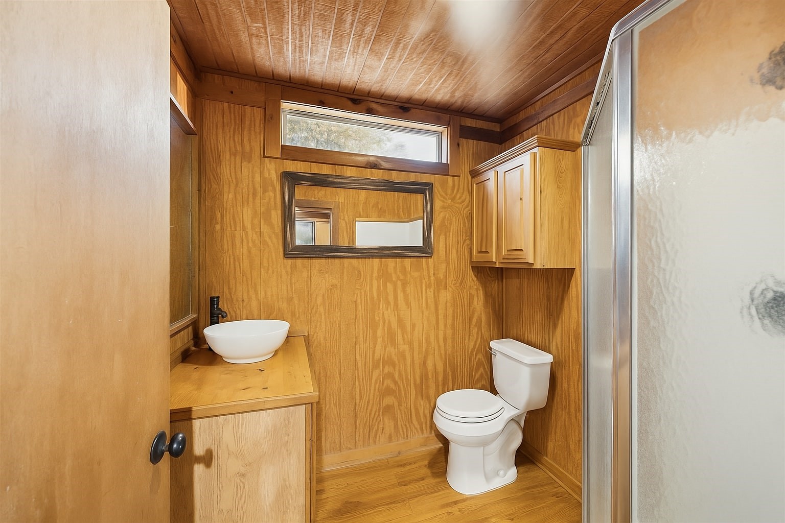 40570 Wildlife Run Hempstead, TX 77445 - Photo 25 of 43 Cozy and well-equipped, this full guest bathroom features a walk-in shower, custom wood cabinetry, and natural textures that echo the home’s country aesthetic. A practical and private space for guests or multi-generational living.