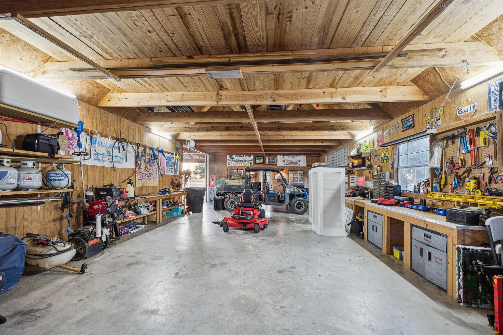 40570 Wildlife Run Hempstead, TX 77445 - Photo 26 of 43 This expansive workshop is a hobbyist’s dream, complete with concrete floors, ample lighting, and built-in workstations. Whether you’re wrenching on a side-by-side or crafting your next project, this space is ready for action.