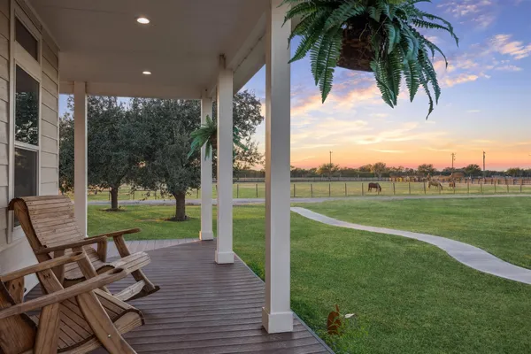 a view of a patio with a table chairs and a backyard