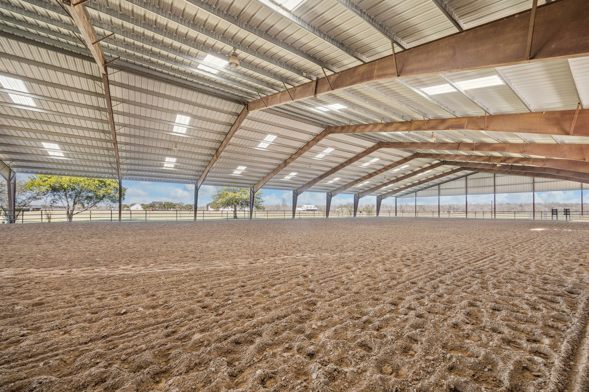 40570 Wildlife Run Hempstead, TX 77445 - Photo 40 of 43 Enjoy the rare luxury of the community covered arena perfect for training, turnout, or all-weather riding. With ample lighting and space to work your horses year-round, this private structure is a dream setup for professionals and passionate equestrians alike.