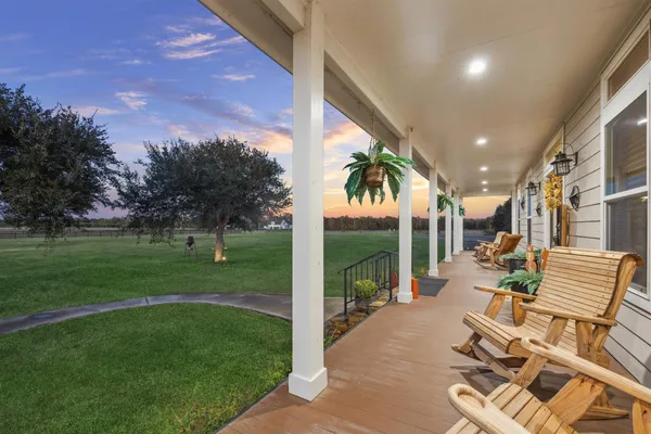a view of a patio with chairs and table in patio