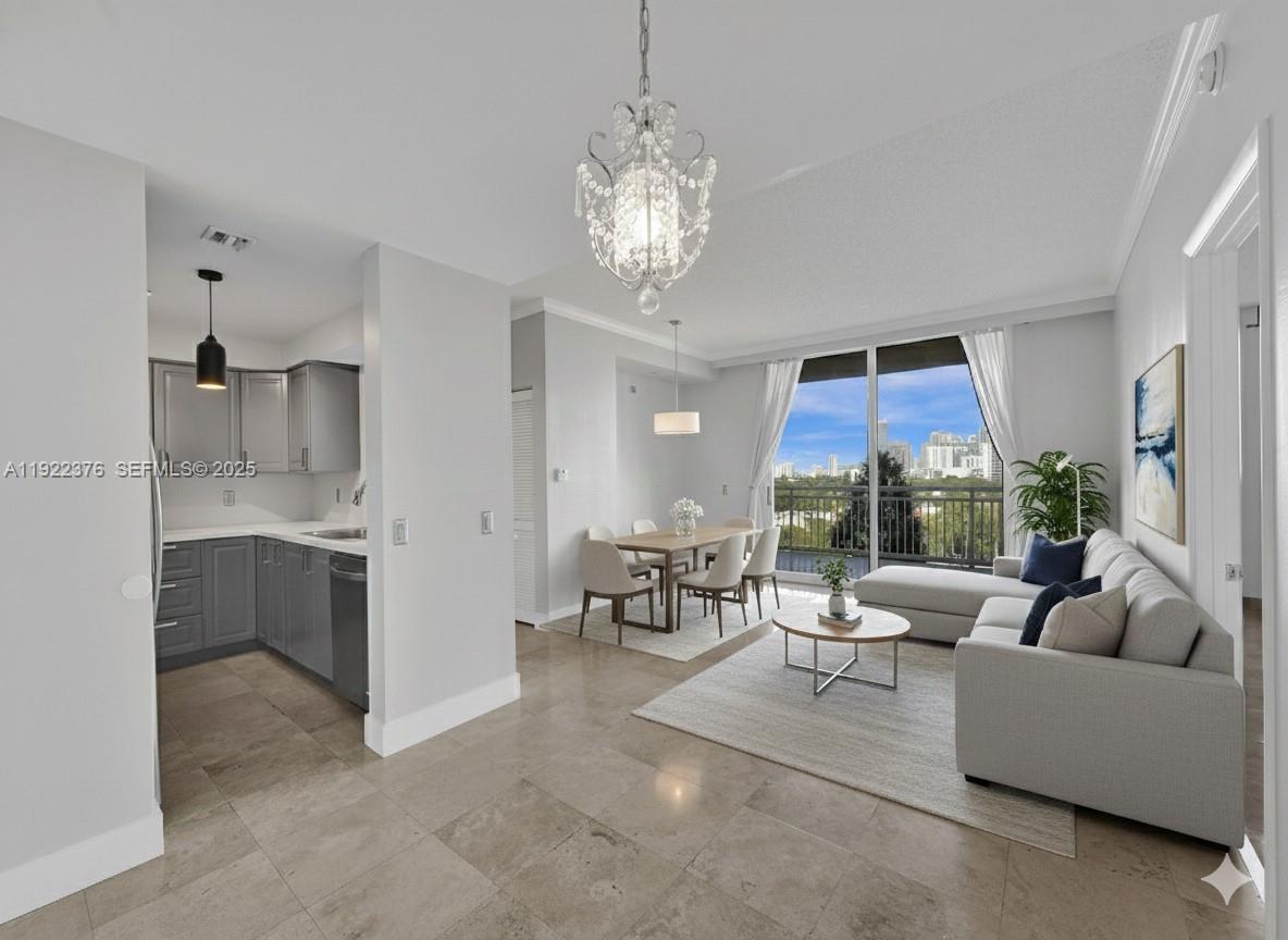 a living room with furniture a fireplace and a chandelier