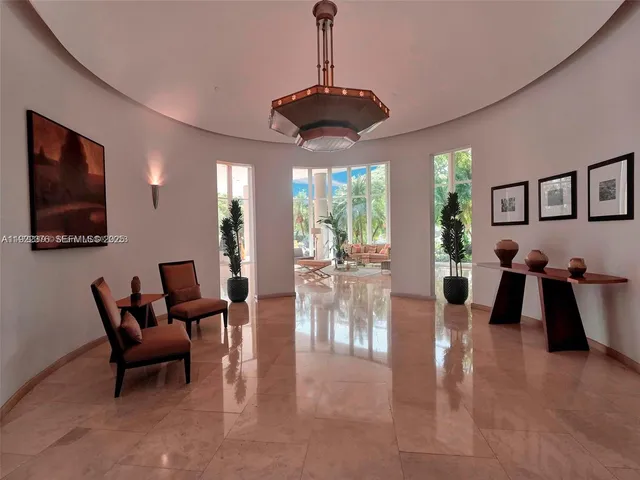 a living room with furniture and large windows